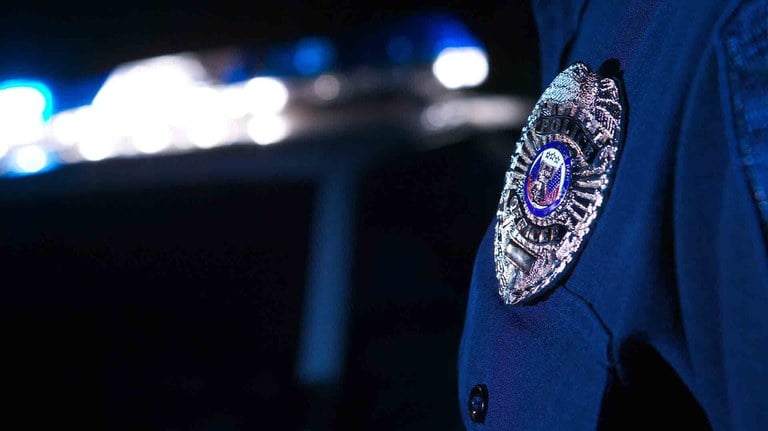 Stock image depicting police badge/patch on officer's sleeve. 